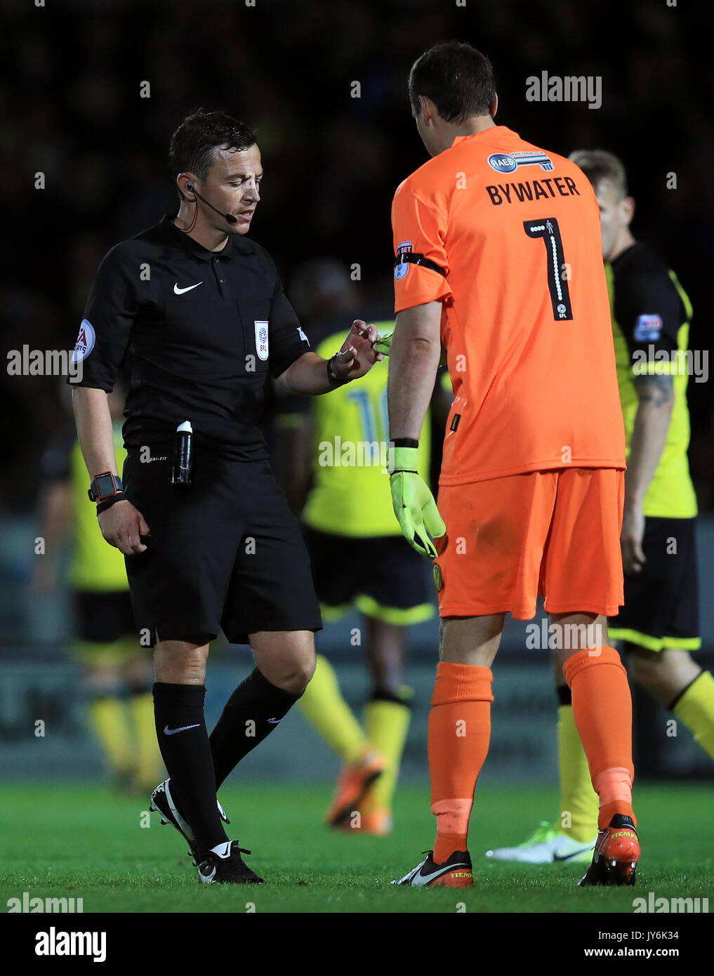 Burton Albion goalkeeper Stephen Bywater hands referee Tony Harrington an object thrown by a member of the crowd during the Sky Bet Championship match at the Pirelli Stadium, Burton. Stock Photo