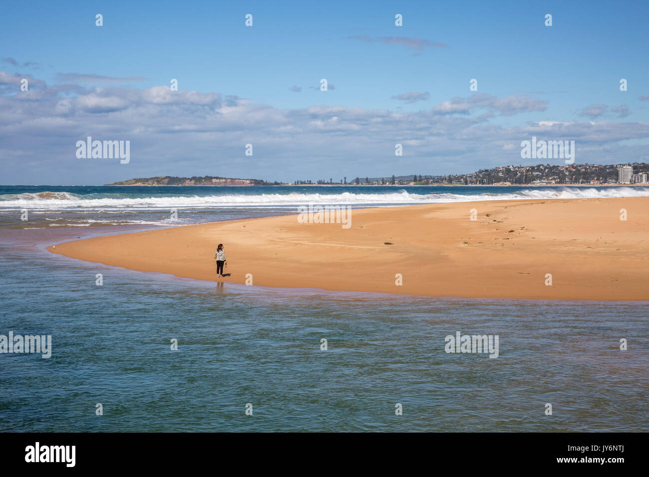 Lady woman on the beach at Narrabeen lagoon aquatic reserve, Sydney