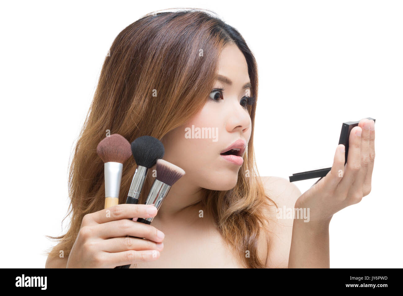 shocked face woman with hand holding make up brush and palette Stock Photo