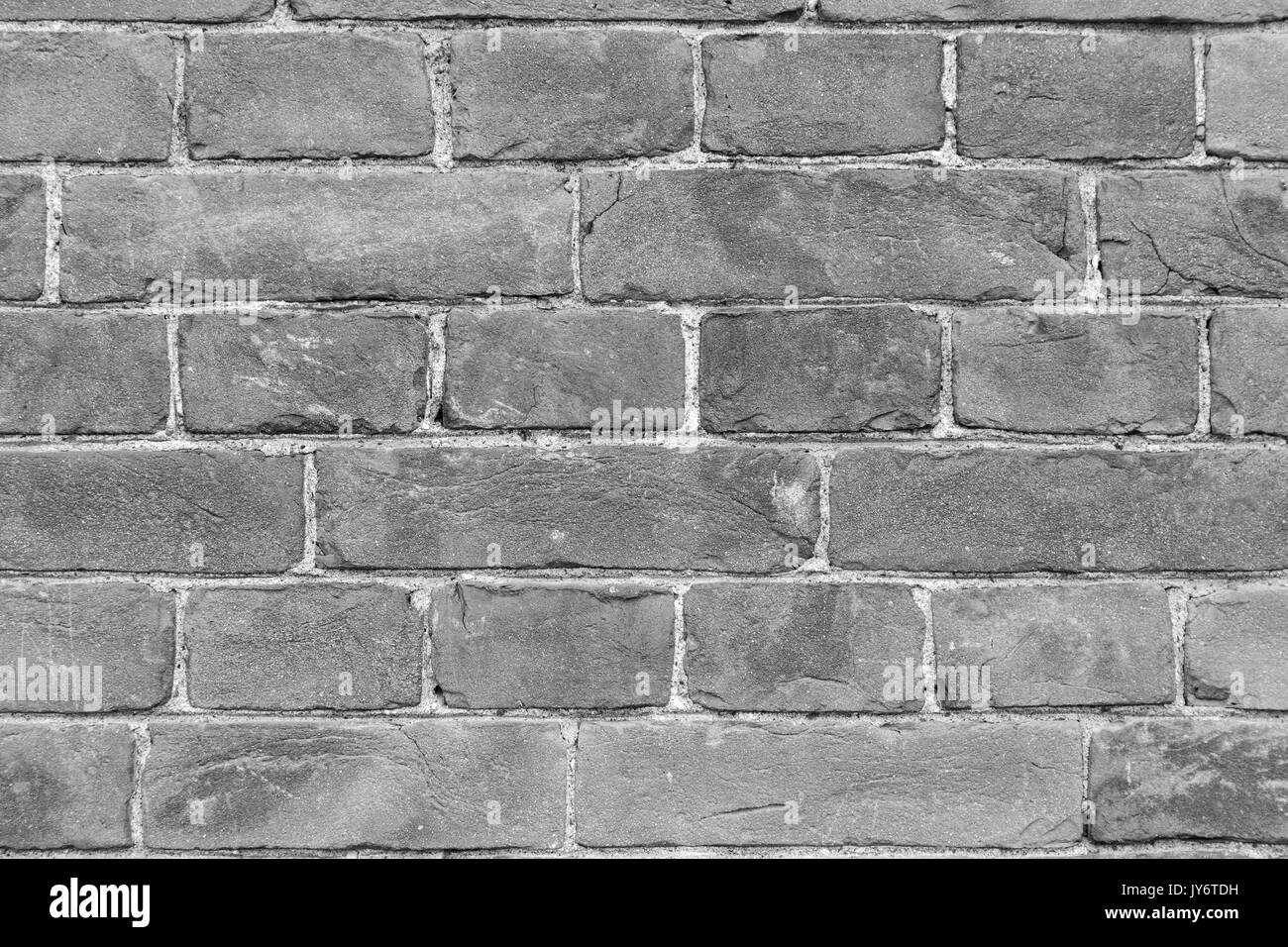 Close-up of an old and aged brick wall texture background in black and ...