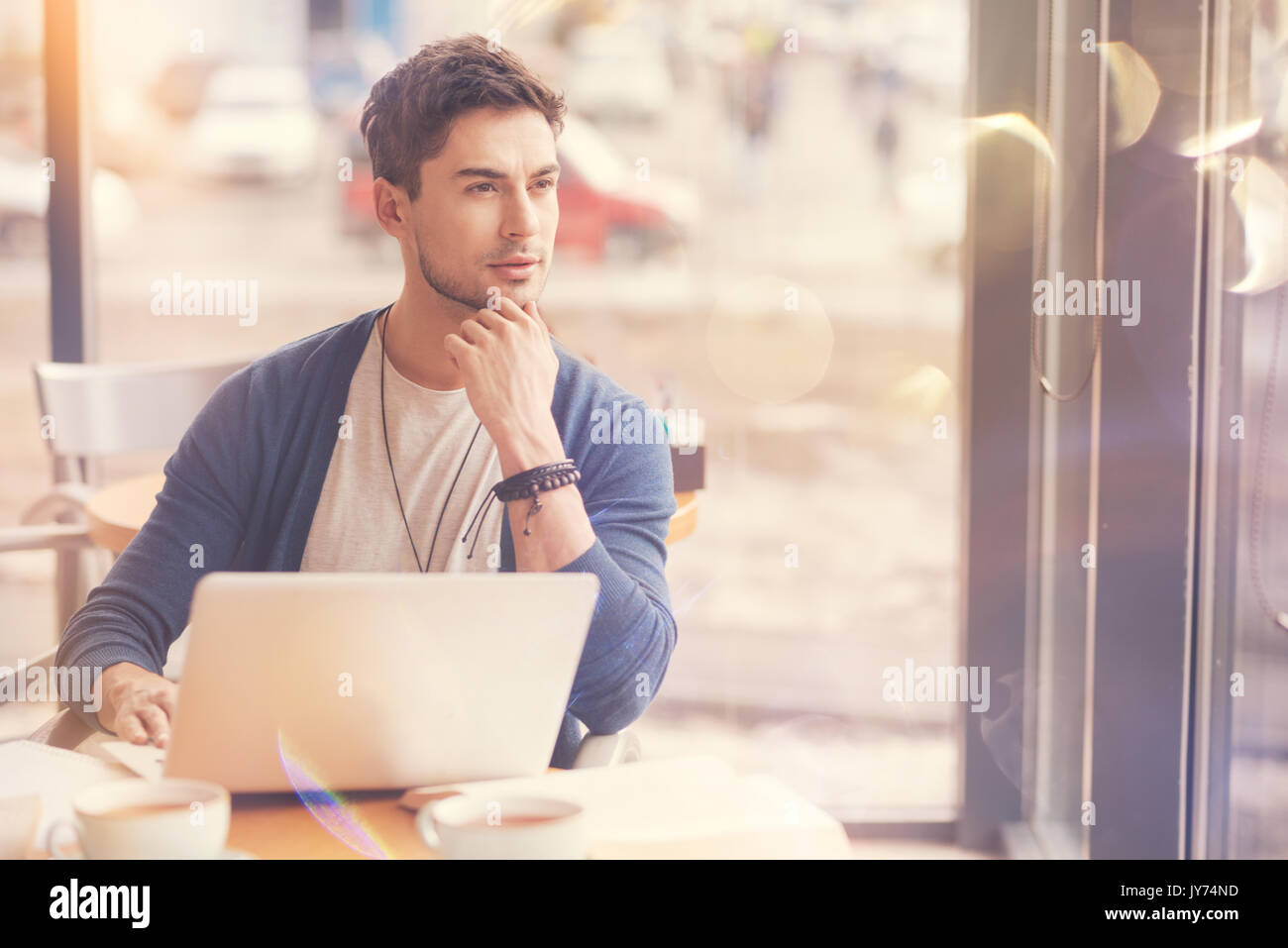 Thoughtful young businessman sitting in the cafe Stock Photo