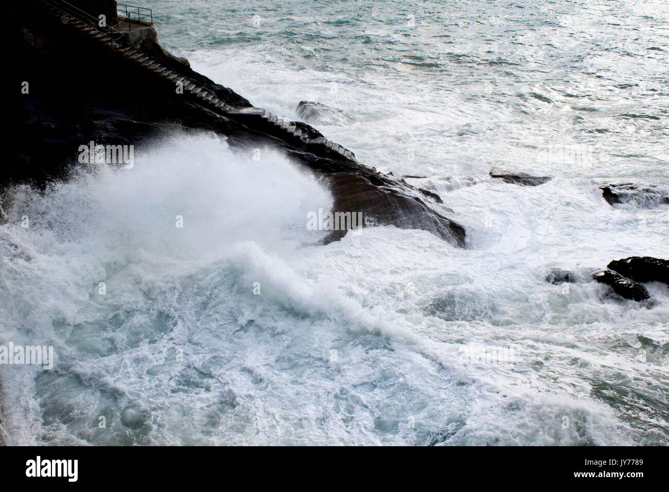Brave sea and access stairs to the dock in the bay of San Sebasian, Spain Stock Photo