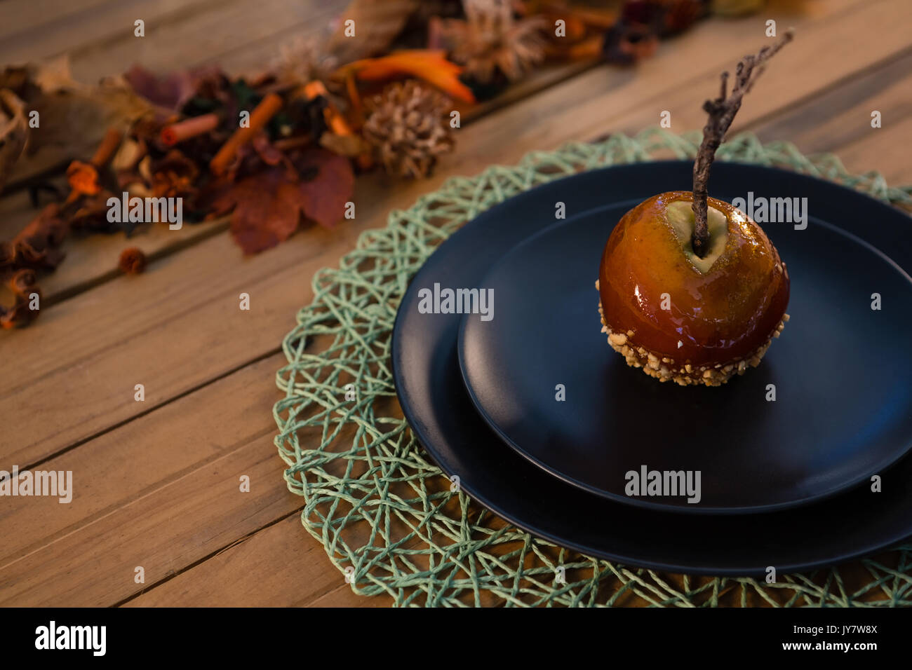 High agnle view of caramelized apple served in plate on wooden table Stock Photo