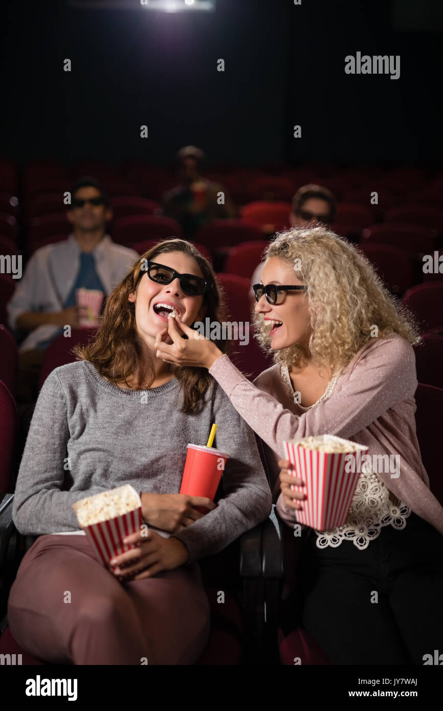 Happy friends watching movie in hi-res stock photography and images - Alamy
