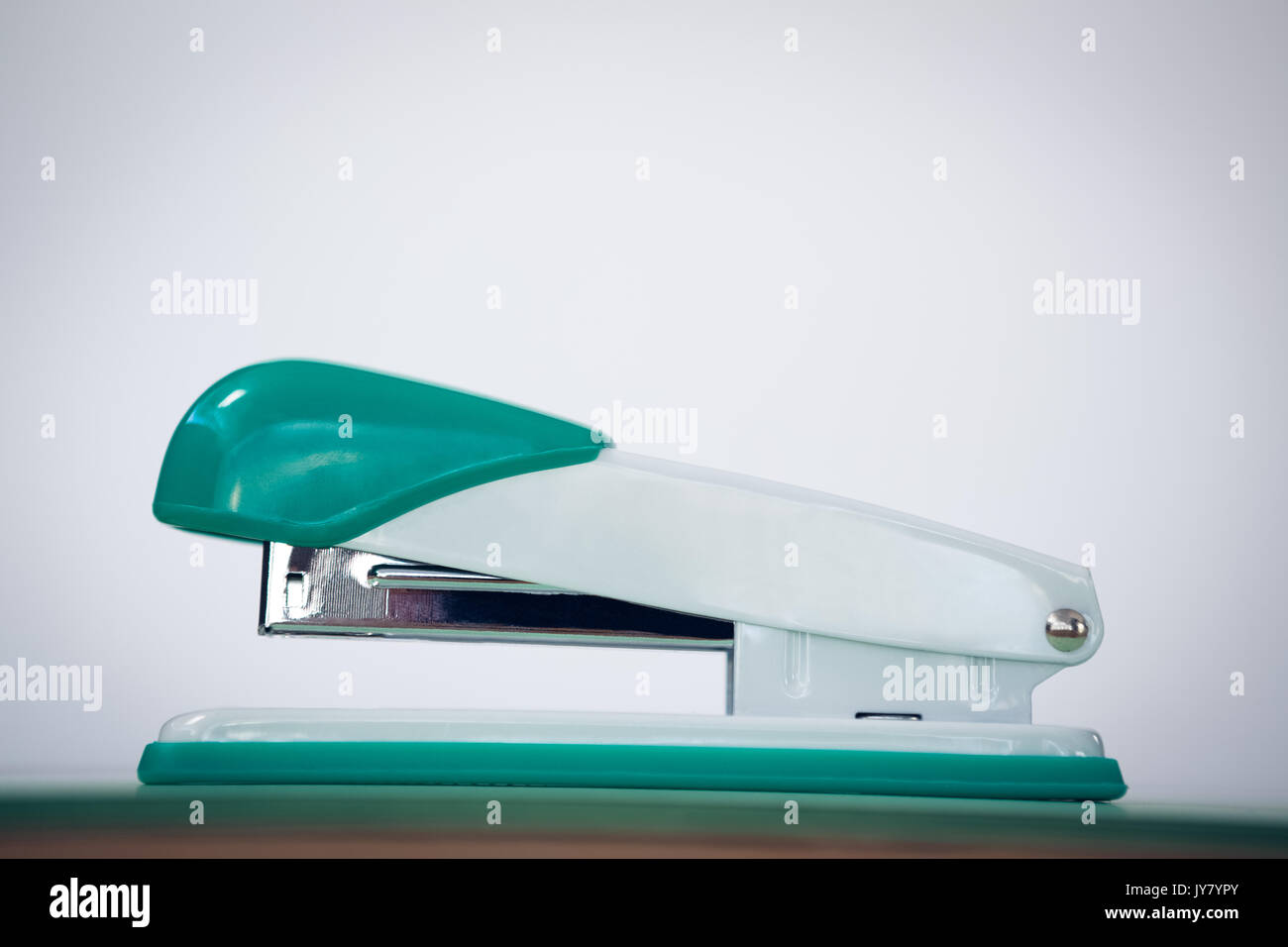 Close up of stapler against wall on table Stock Photo