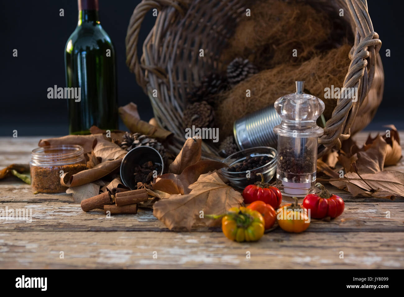 Spice by container on wooden table against black background Stock Photo