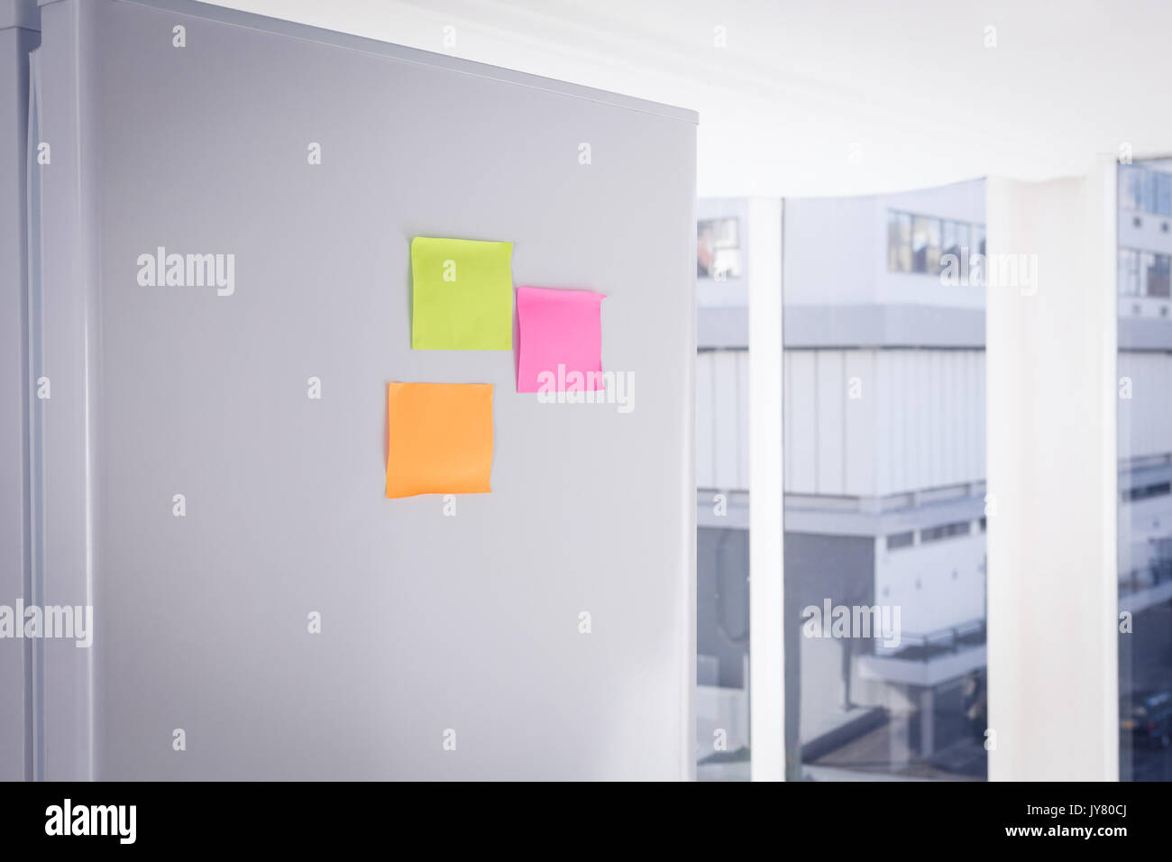 Adhesive notes stuck on refrigerator Stock Photo