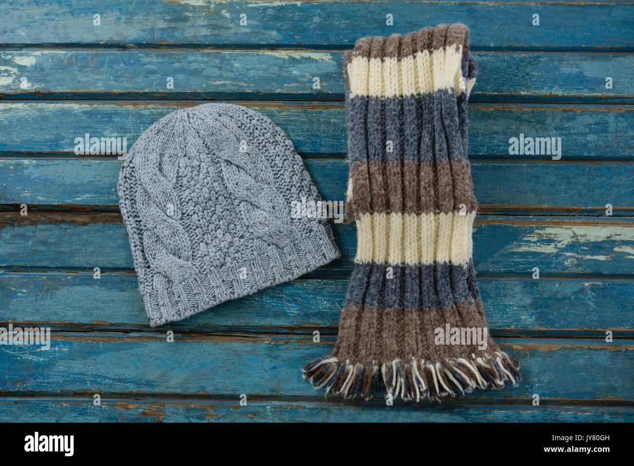 Overhead view of knit hat and scarf on wooden table Stock Photo