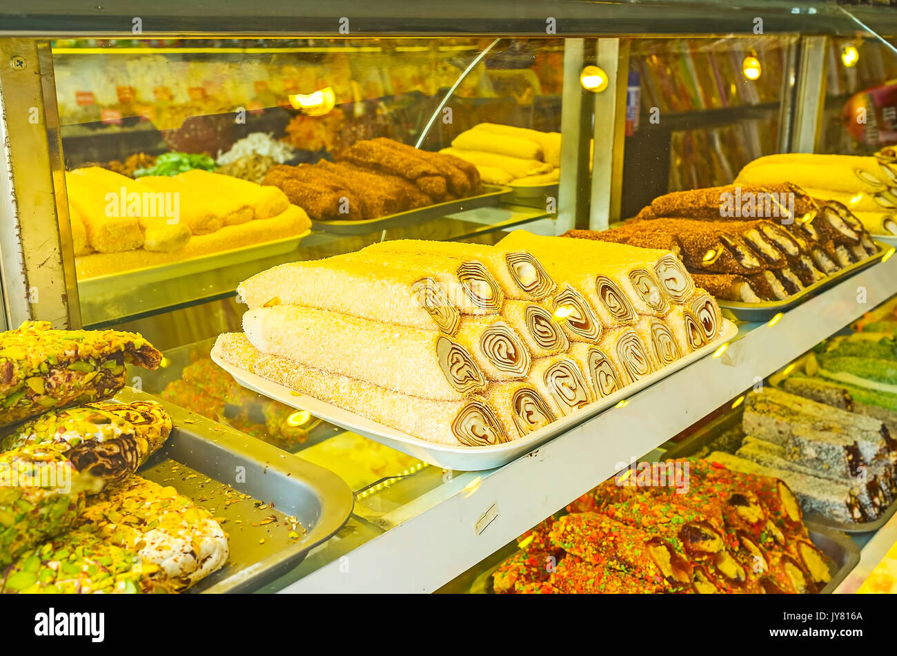 Attractive showcase of the candy store of tourist market with sweet rolls  of rahat lokum, these dessert include fruit jelly, nuts, dried fruits,  choco Stock Photo - Alamy