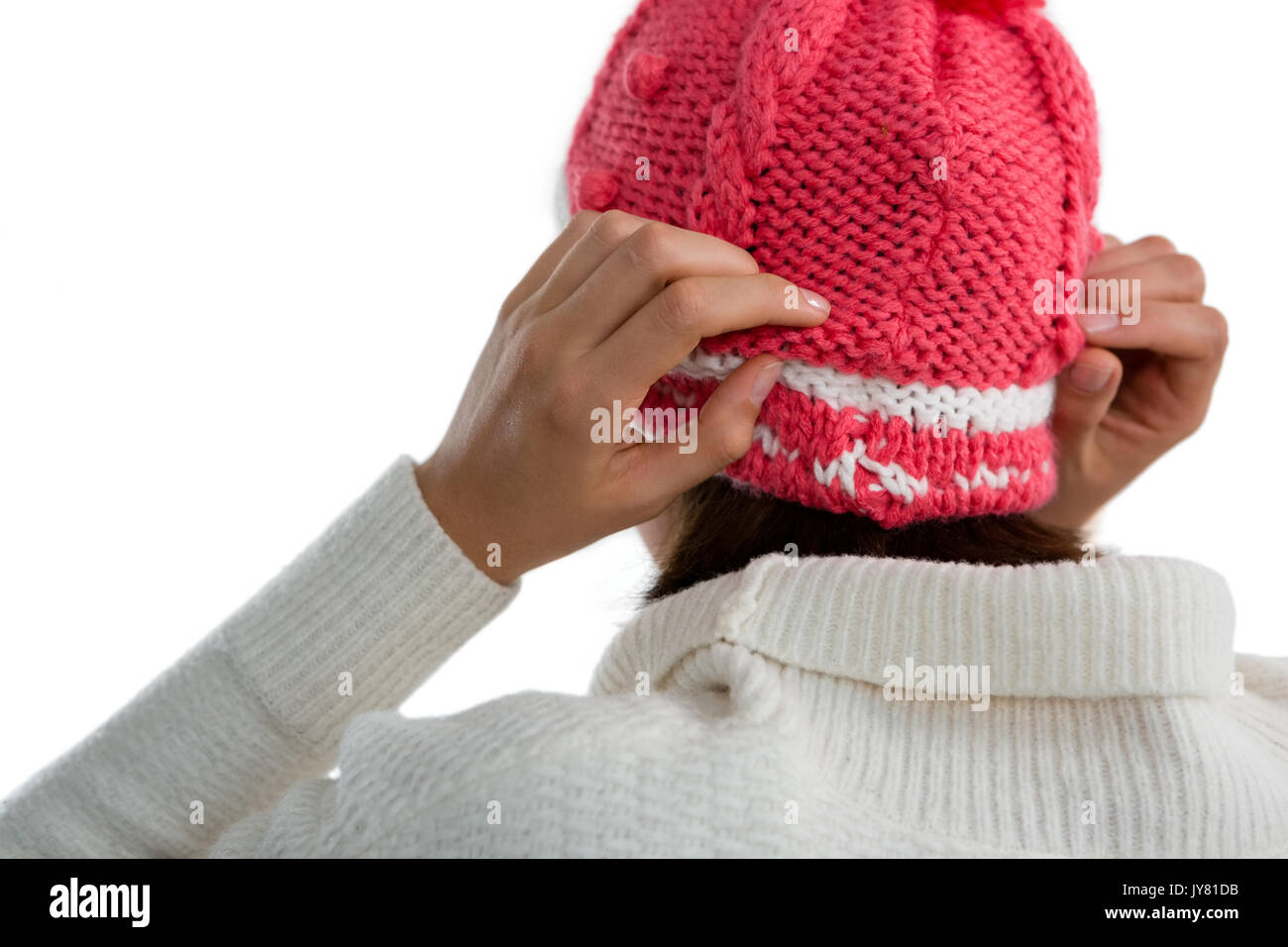 Rear view of woman wearing knit hat against white background Stock Photo