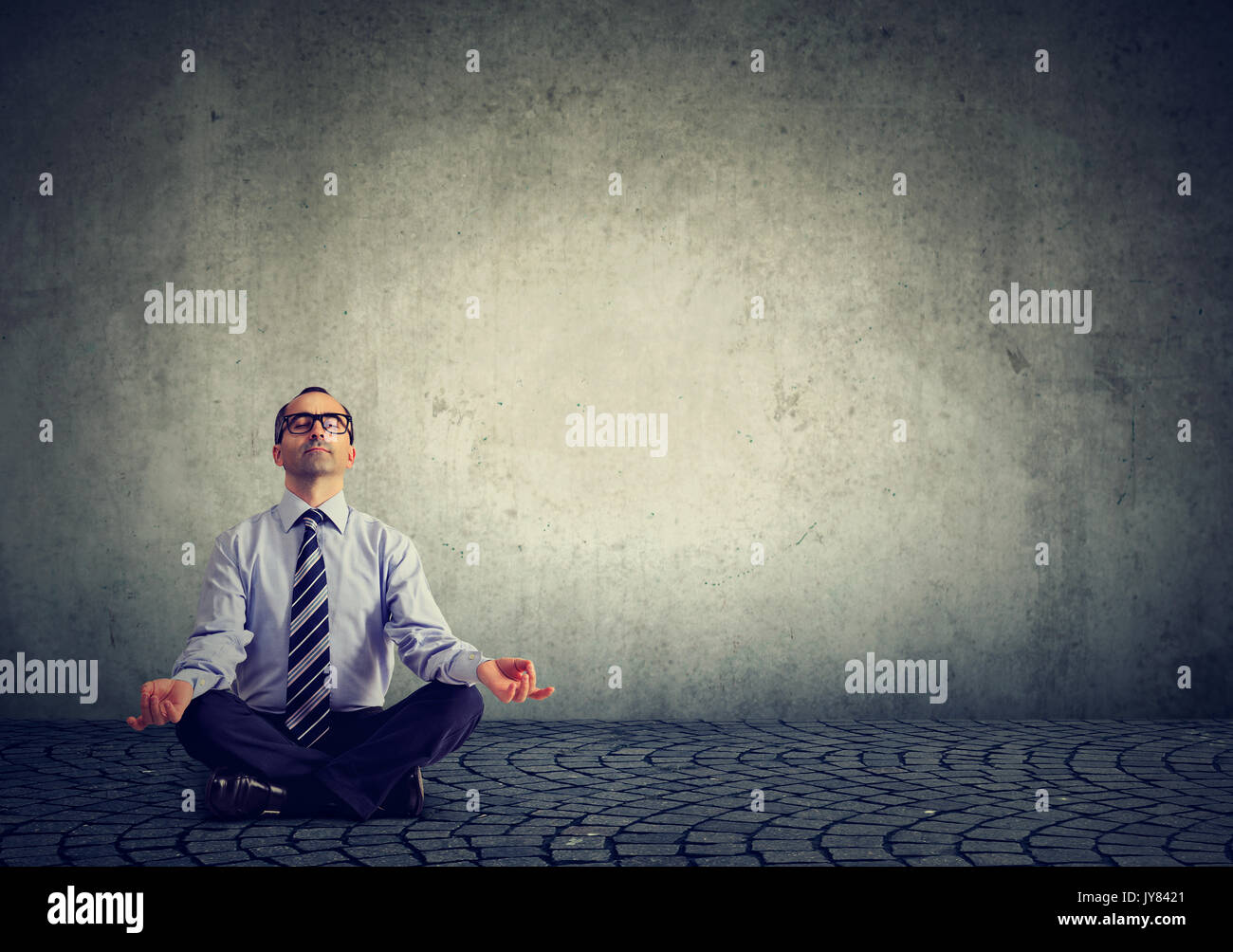 Business man meditating relaxing with eyes closed Stock Photo - Alamy