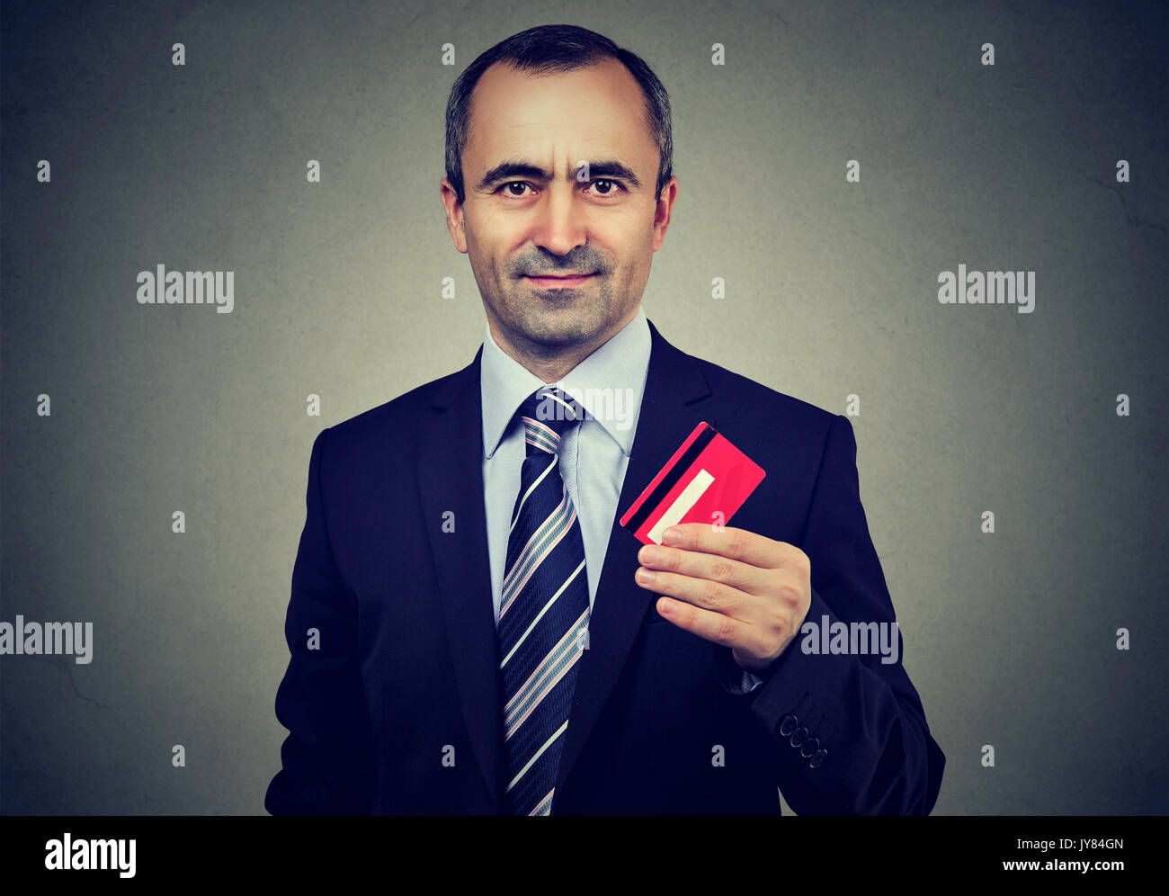 Happy business man offering new credit card Stock Photo