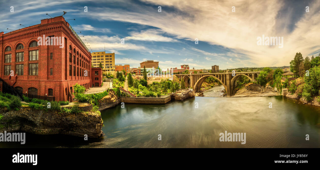Panoramic cityscape view of Washington Water Power building and the Monroe Street Bridge along the Spokane river, in Spokane, Washington. Stock Photo