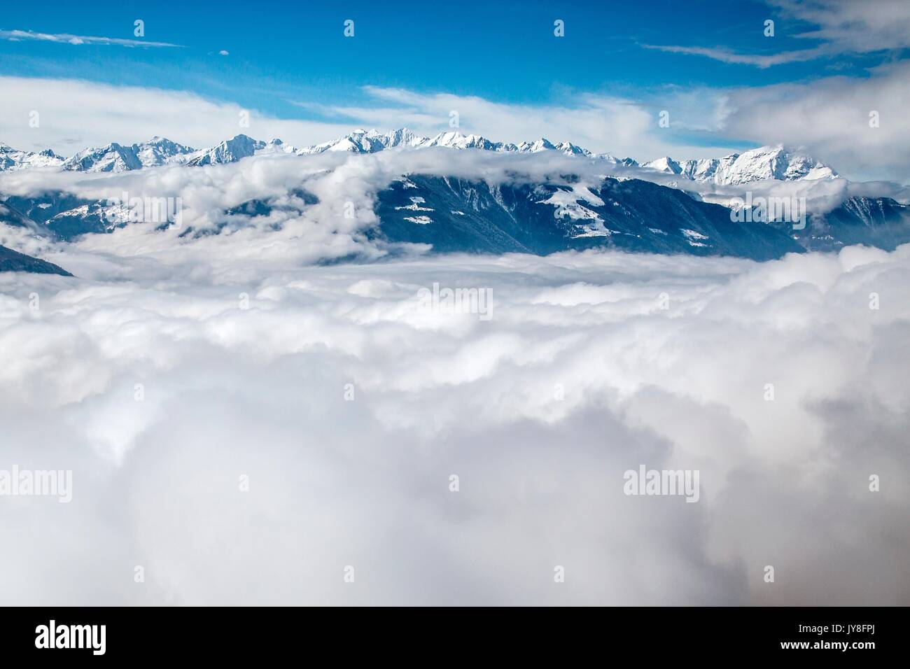 Snowy peaks of Val Gerola emerging from the fog Lower Valtellina, Lombardy Italy Europe Stock Photo