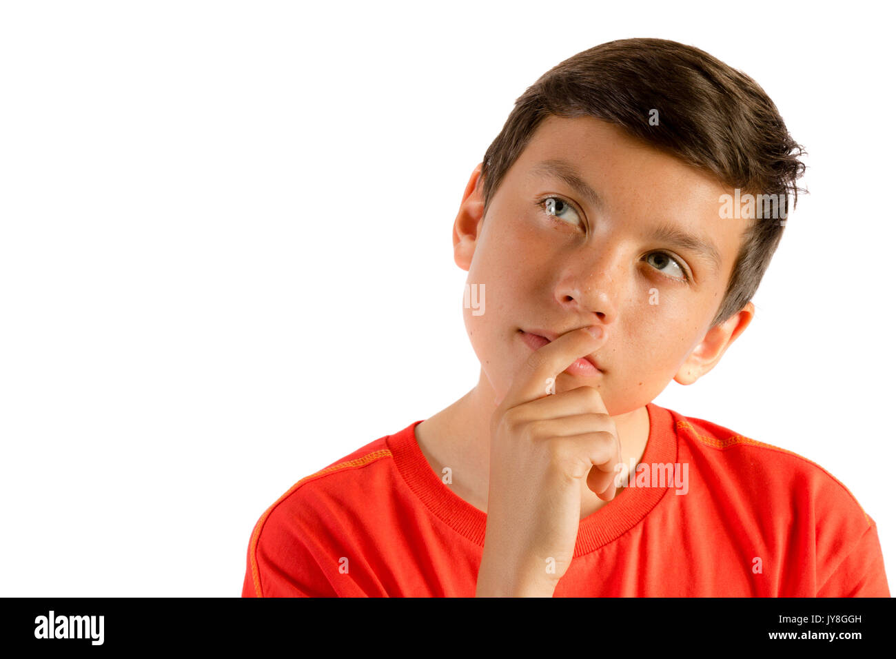 Young teenage boy isolated on white thinking Stock Photo