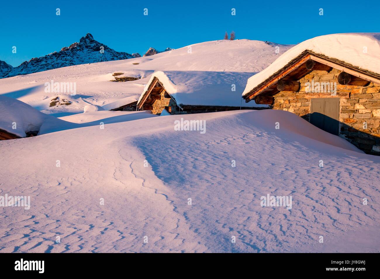 Huts at the Alpe Prabello, Prabello Alp at the sunset, Valmalenco, Valtellina, Italy Stock Photo