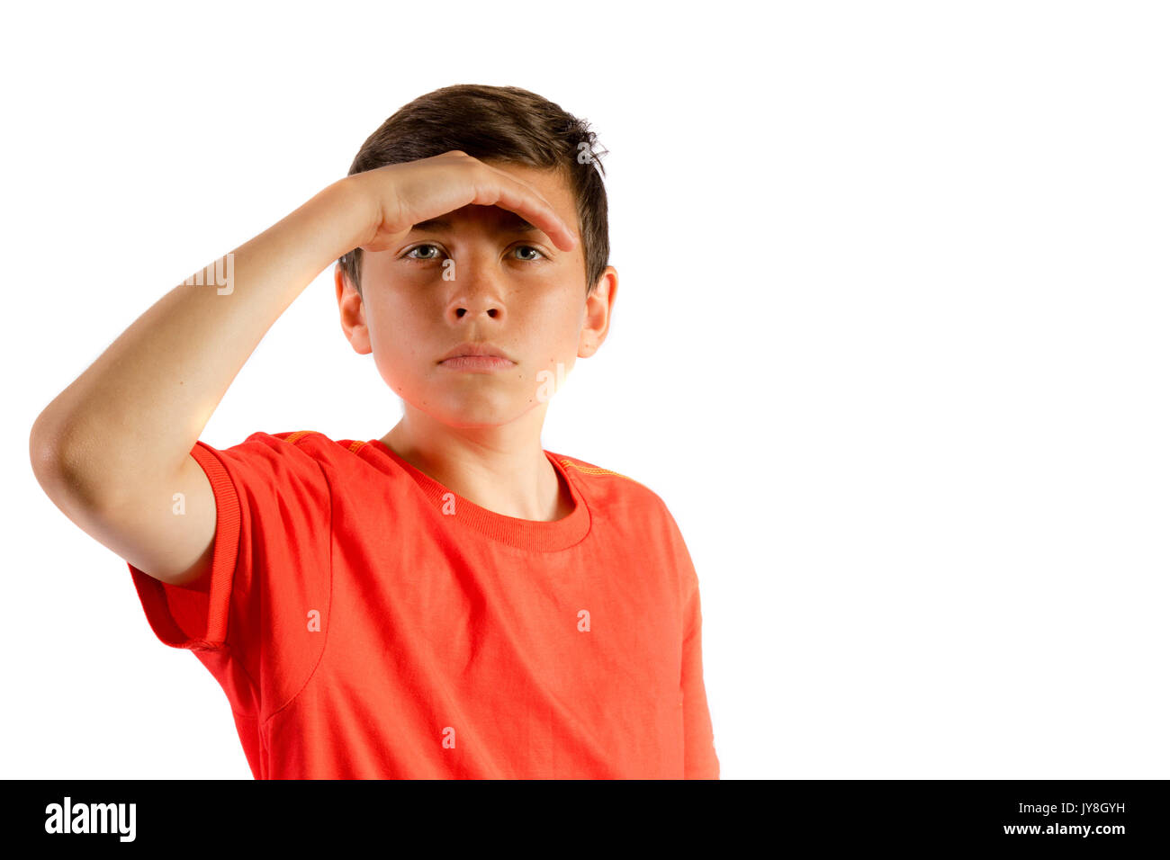 Young teenage boy isolated on white shielding his eyes Stock Photo