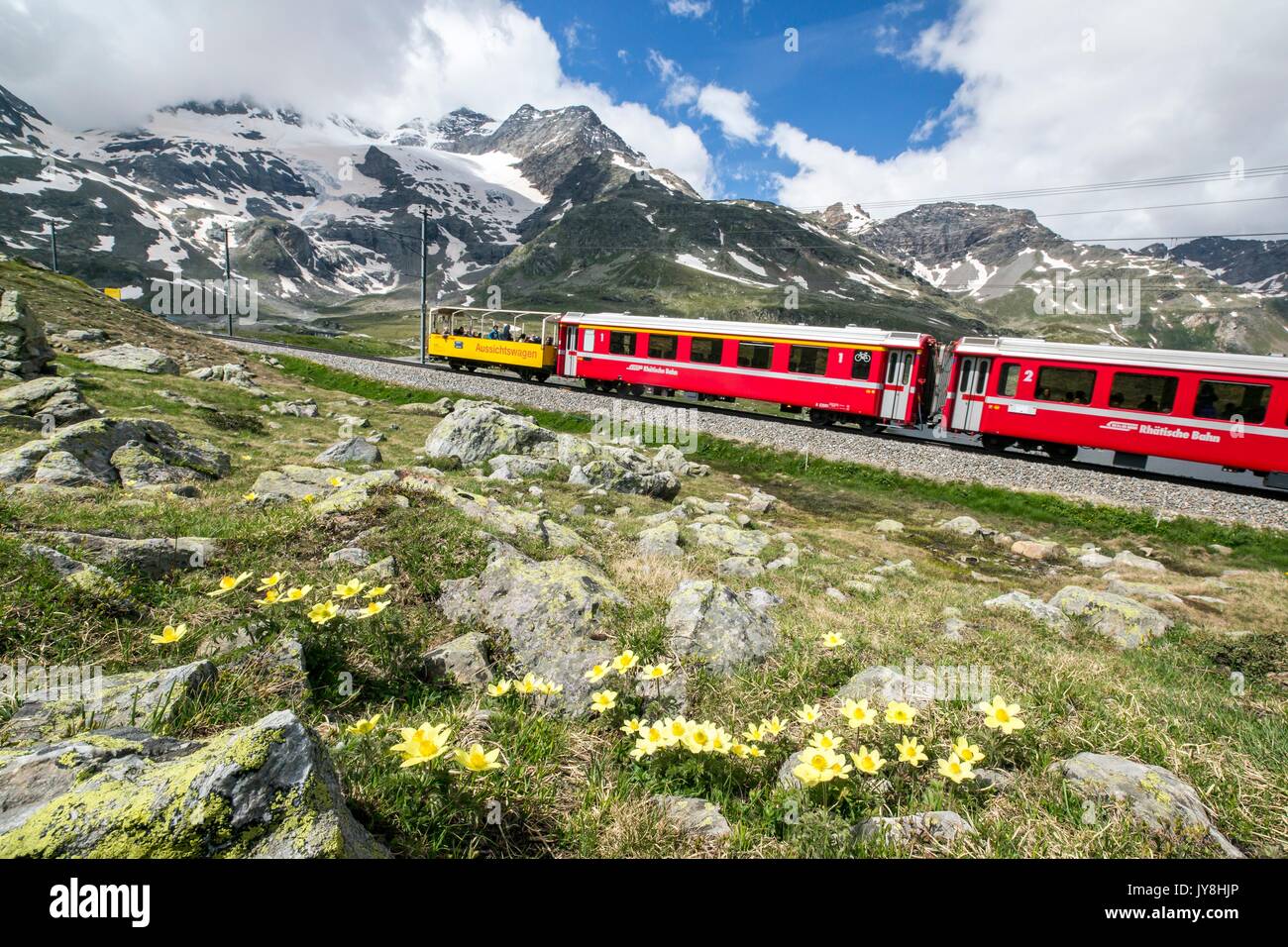 The red train, the icon of the Raethian Railway, travelling near Bernina Pass. Pontresina Engadine Canton of Graubunden Switzerland Europe Stock Photo