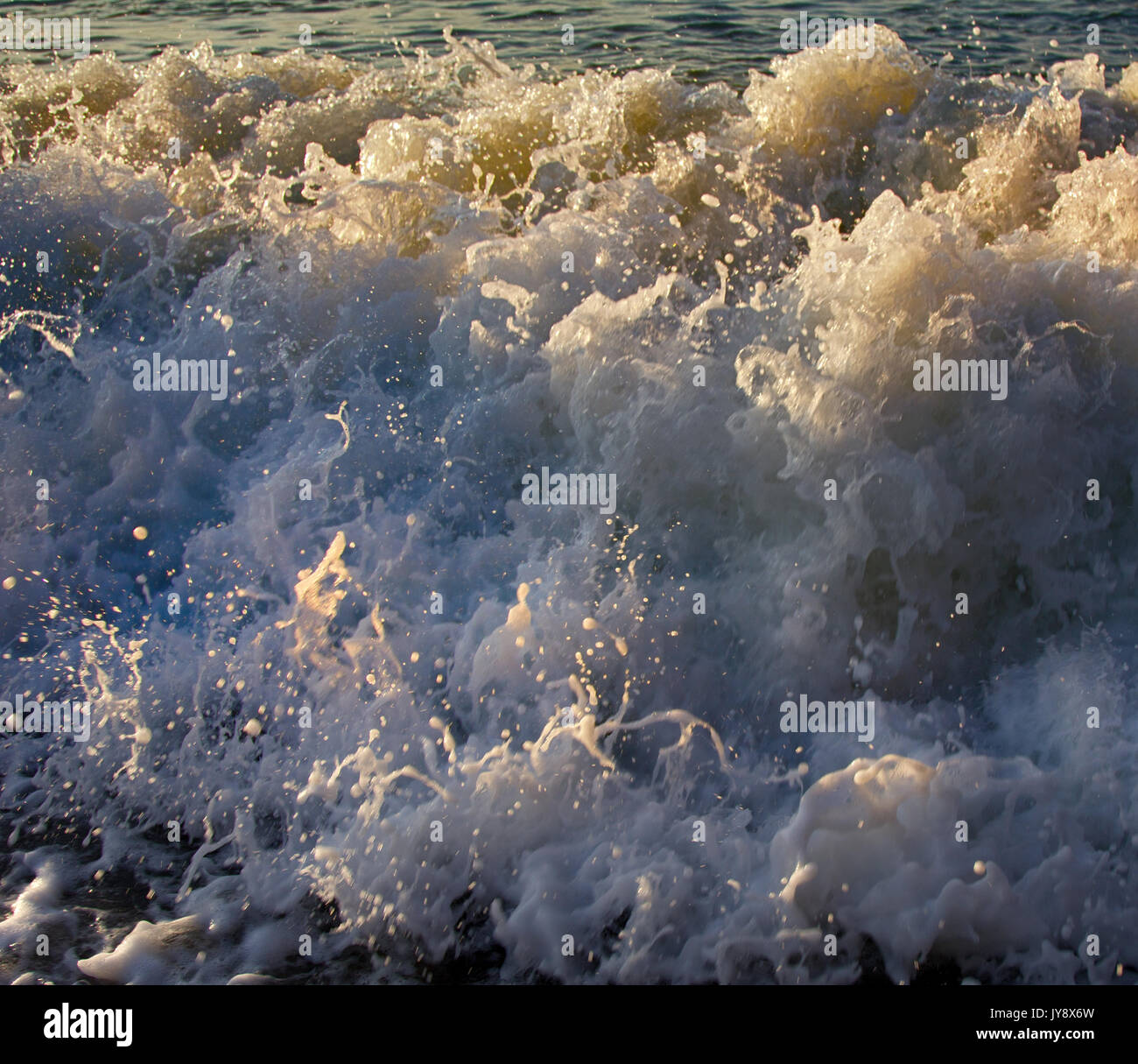 Raging sea rolling in rays of setting sun. Black sea, Caucasus Stock ...