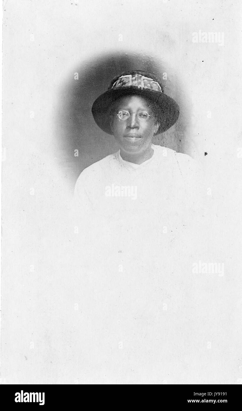 Headshot of mature African American woman, wearing hat, neutral ...