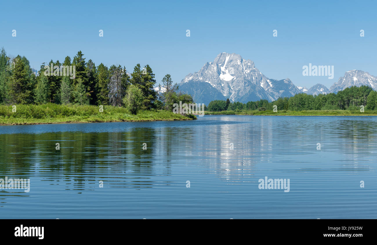 The light blue colours of the Snake river by the oxbow bend with a reflection of the Grand Teton range, Wyoming state, United States of America (USA). Stock Photo