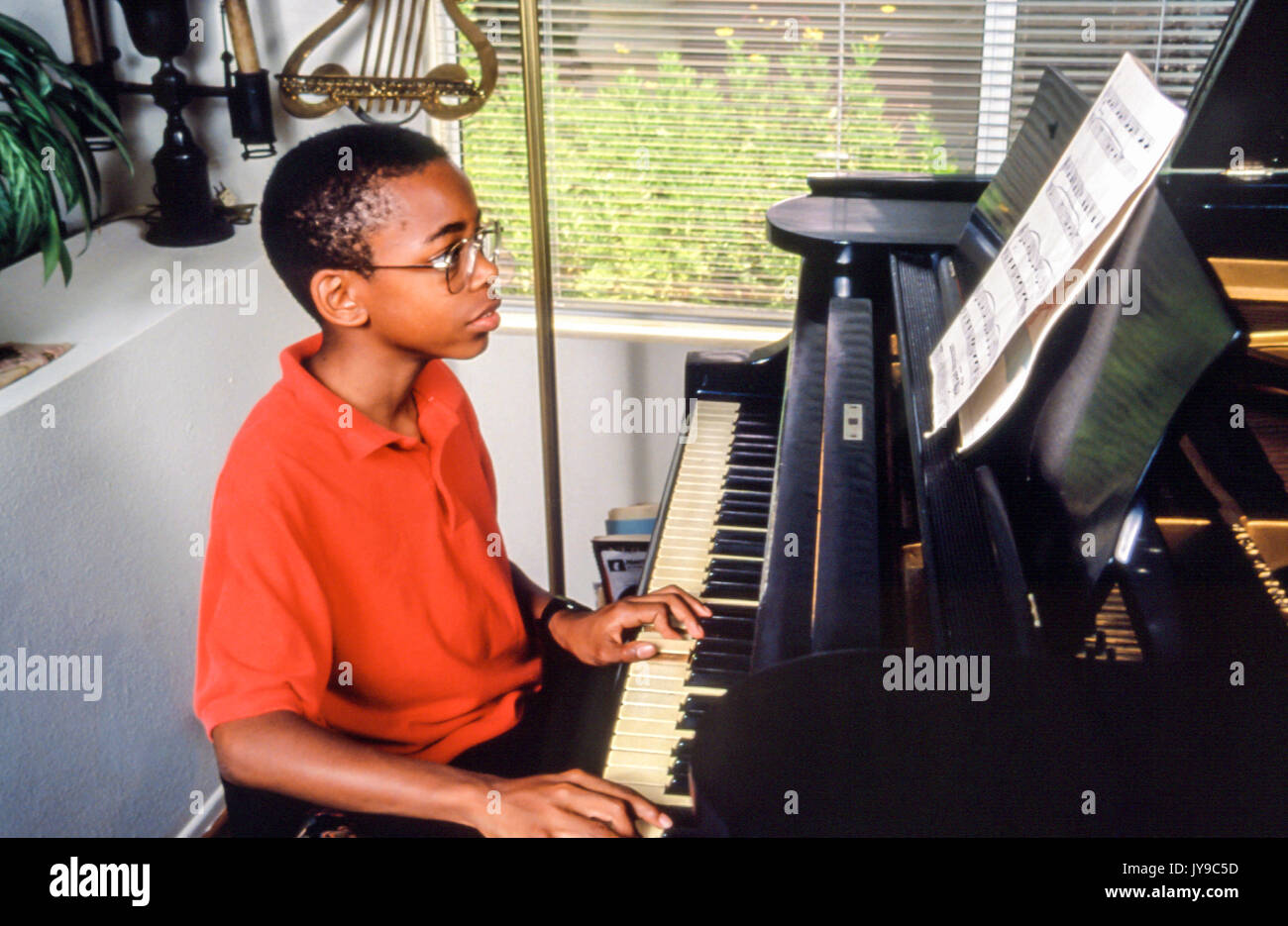 Young person Tween tween boy practicing practices piano lesson music