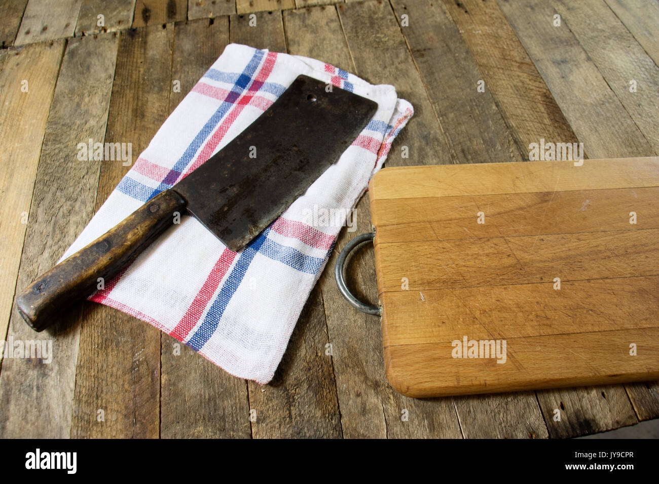 large chef knife sticks out from wooden cutting board om black shabby  wooden background. Red onion by Moon Soul. Photo stock - StudioNow