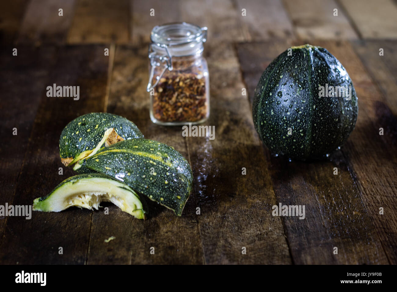 Tasty pumpkin and spices on a wooden kitchen table, black background ...