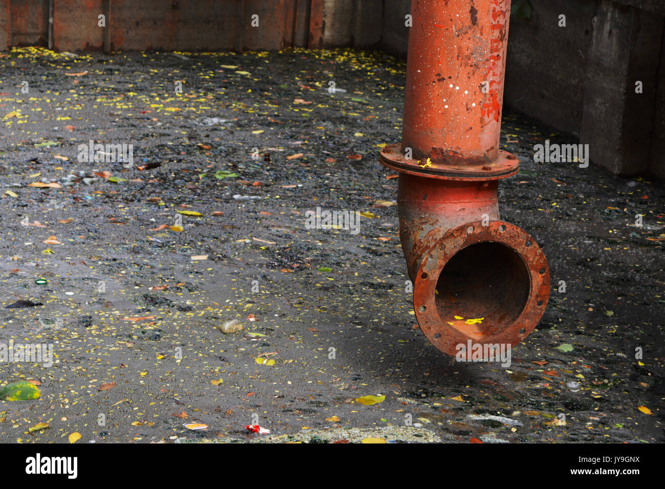 Colorful tube on dark sewage with dirty water Stock Photo