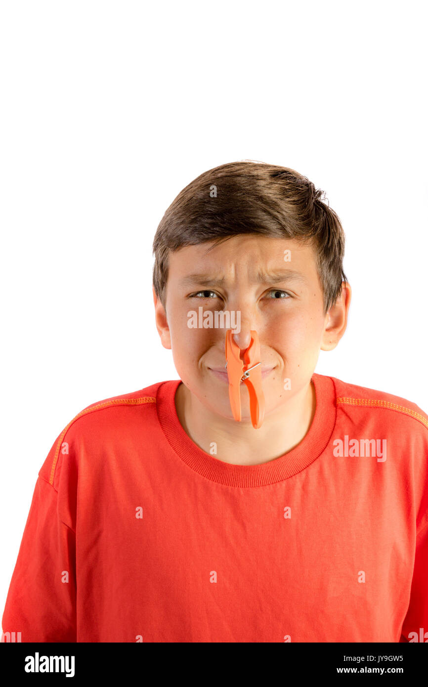 Young teenage boy isolated on a white background with a clothes peg on