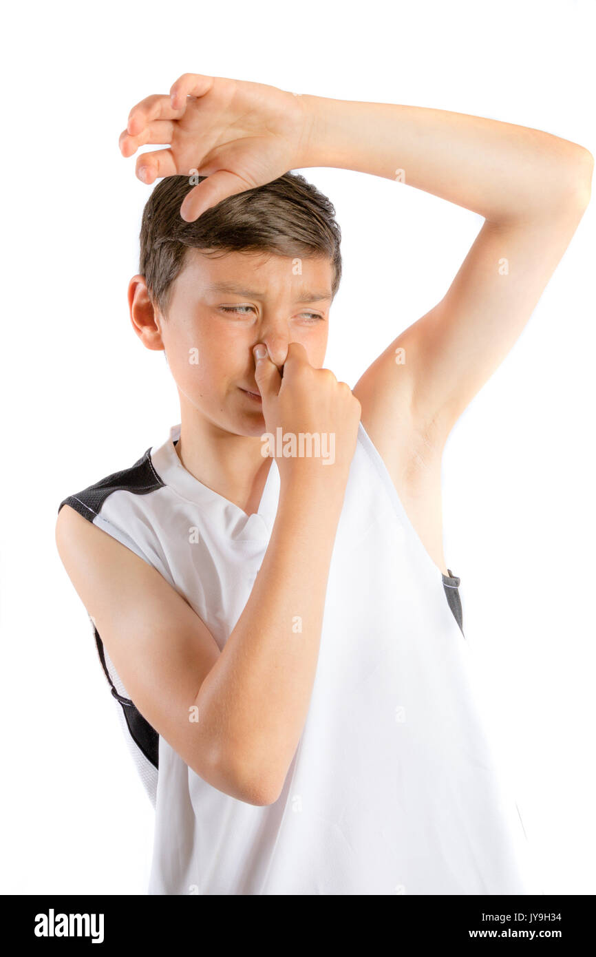 Young teenage boy isolated on a white background with smelly armpit Stock Photo