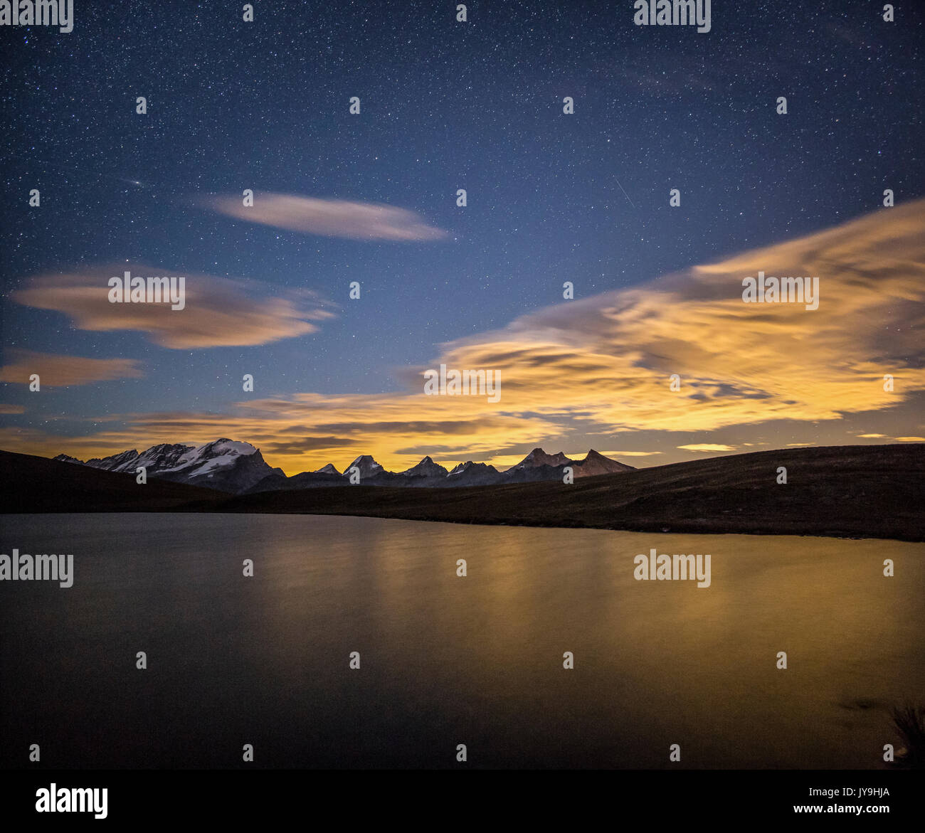 Starry night on Gran Paradiso range view from Lake Rosset.  Alpi Graie. Hill of Nivolet. Stock Photo
