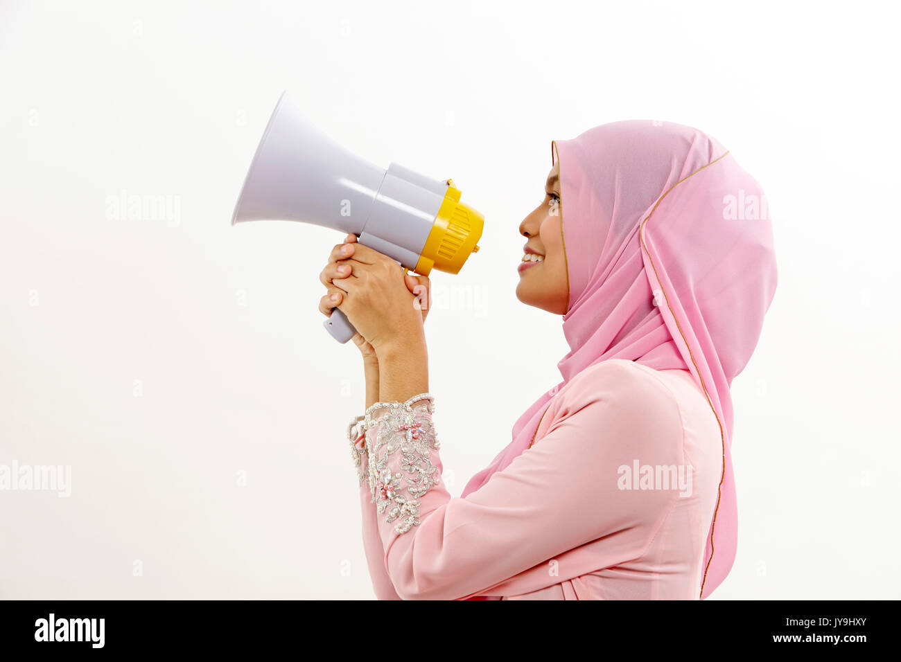 malay woman speaking into a megaphone making a public announcement