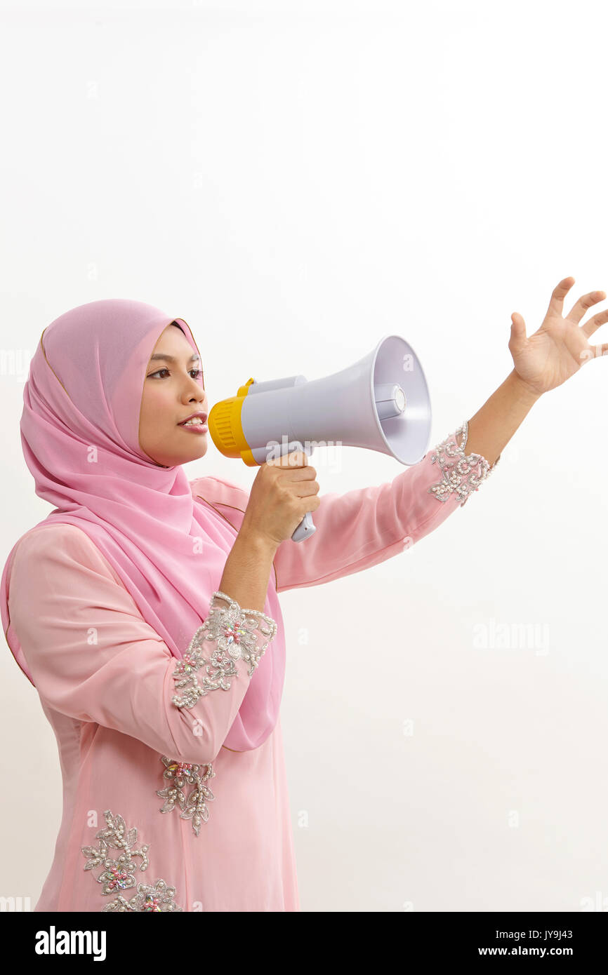malay woman speaking into a megaphone making a public announcement