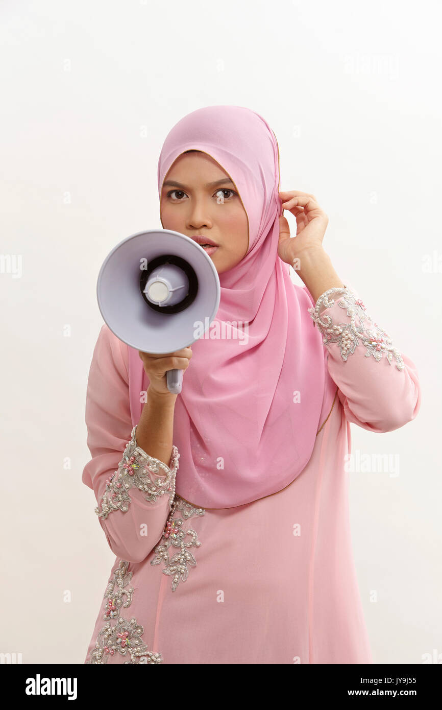 malay woman speaking into a megaphone making a public announcement