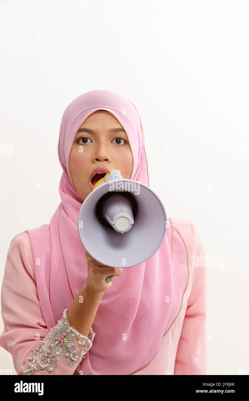 malay woman speaking into a megaphone making a public announcement