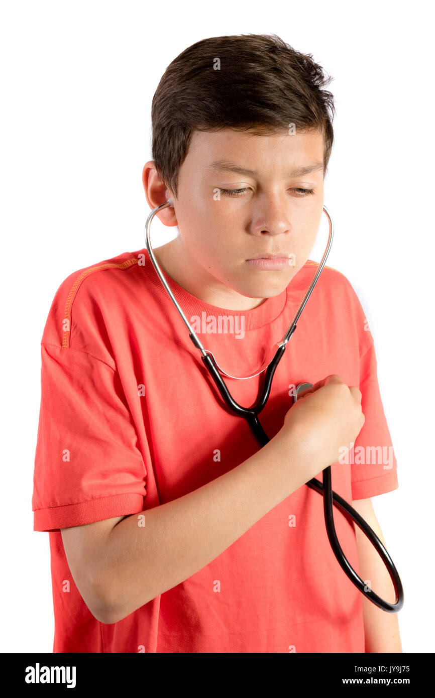 A young teenage boy isolated against white background listening with a stethoscope Stock Photo