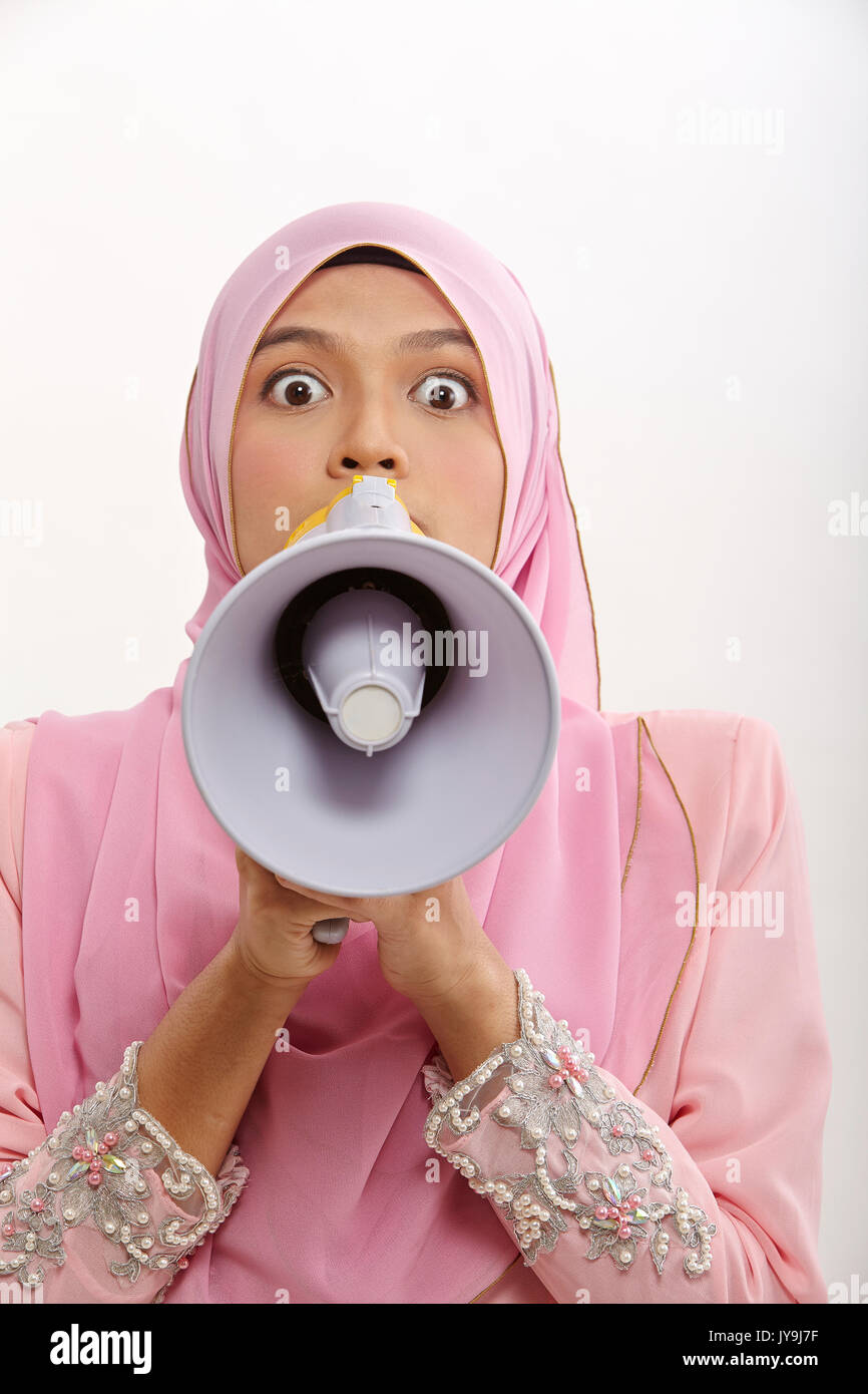 malay woman speaking into a megaphone making a public announcement