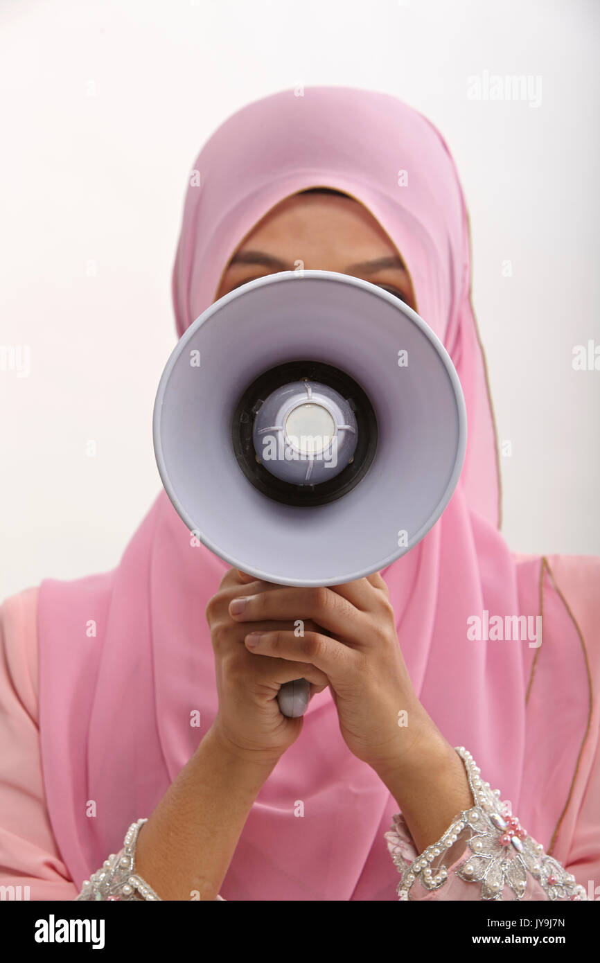 malay woman speaking into a megaphone making a public announcement