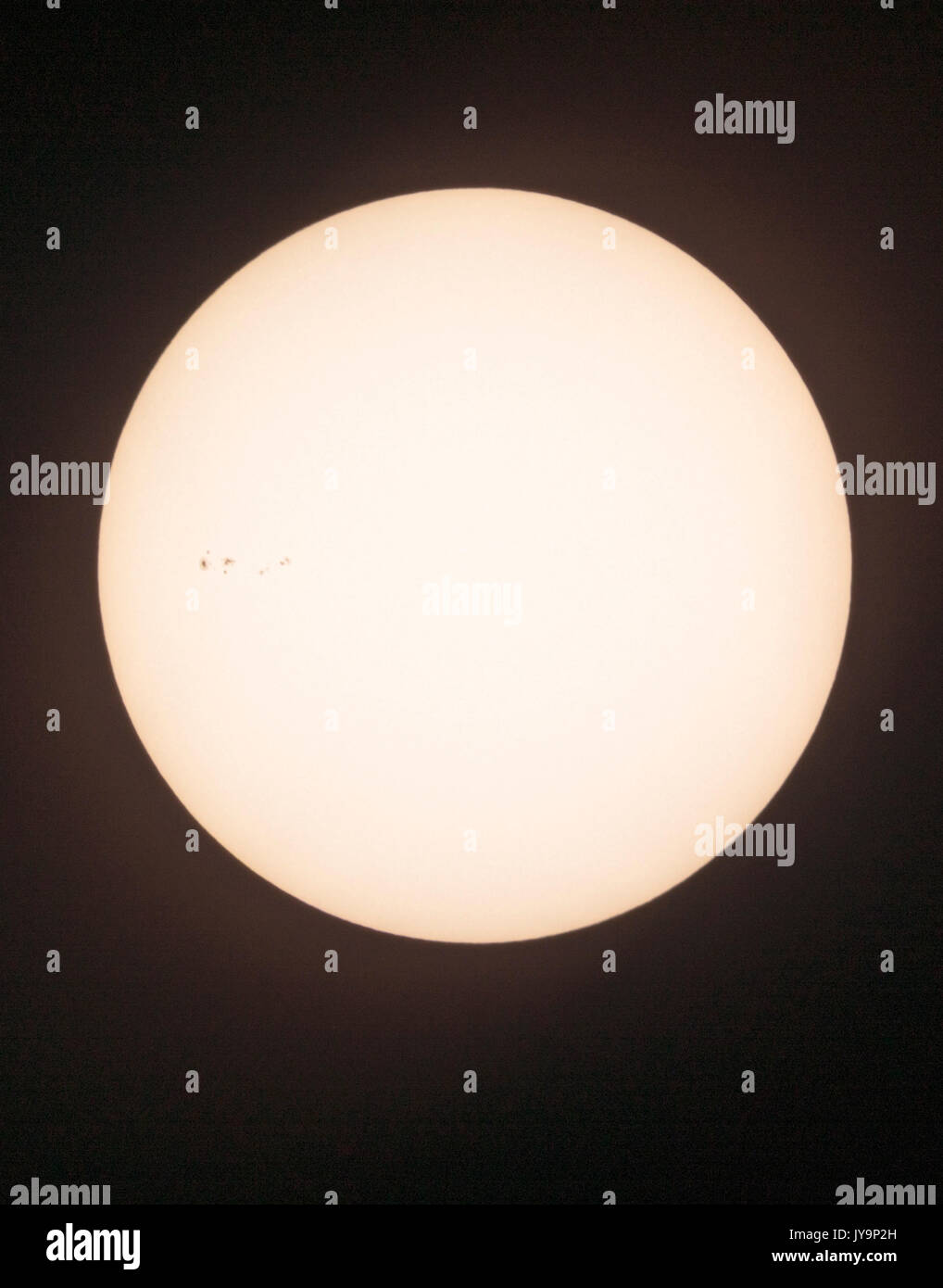 Photograph of the midday sun showing sunspots; cooler regions of the