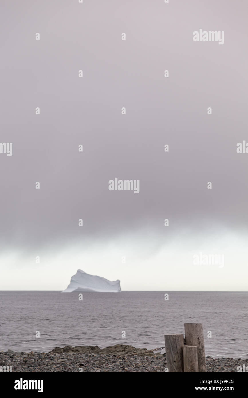 Large iceberg on the sea at sunset with a partly cloudy sky in Torbay
