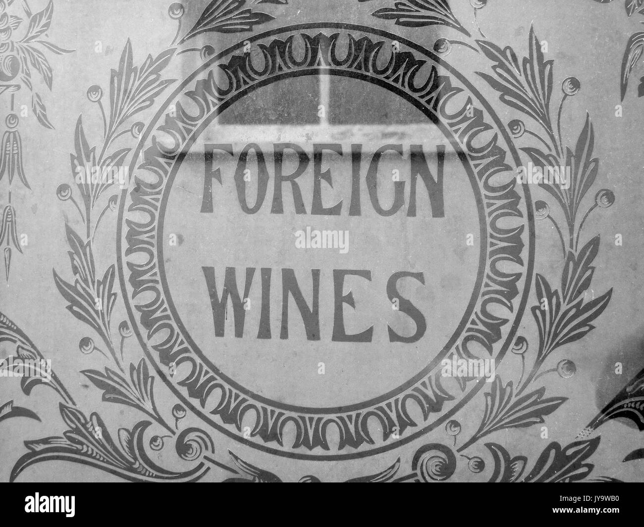 Old foreign wines advertisement sign etched into public house window Stock Photo