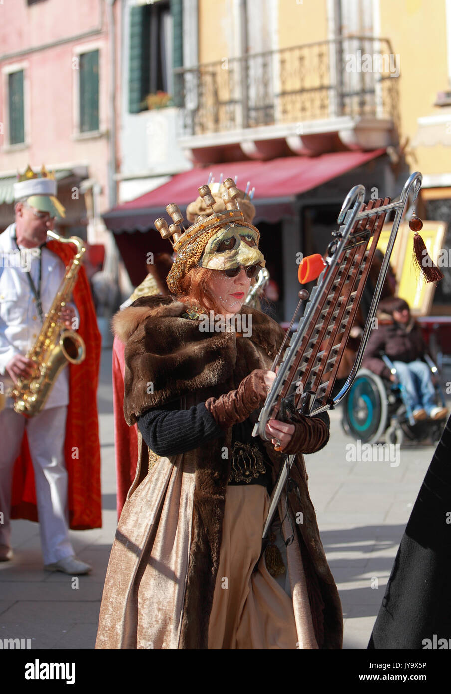 Venice,Italy,February 26th 2011: Portrait of a funny woman xylophone player during a musical parade in Venice during The Carnival days.The Carnival of Stock Photo