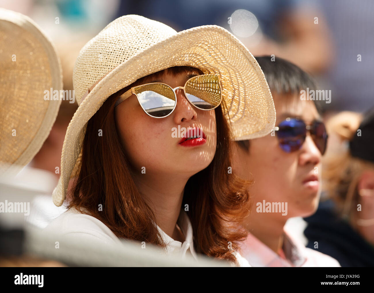 Female  asian tennis spectator with sunglasses at Wimbledon Championships 2017, London, Great Britain, United Kingdom. Stock Photo