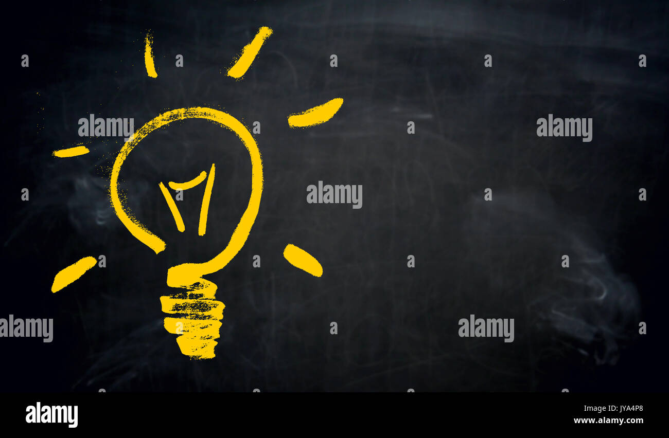Light bulb with copyspace on blackboard painted concept. Stock Photo