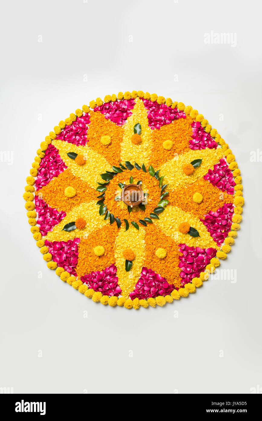 flower rangoli for Diwali or pongal made using marigold or zendu ...