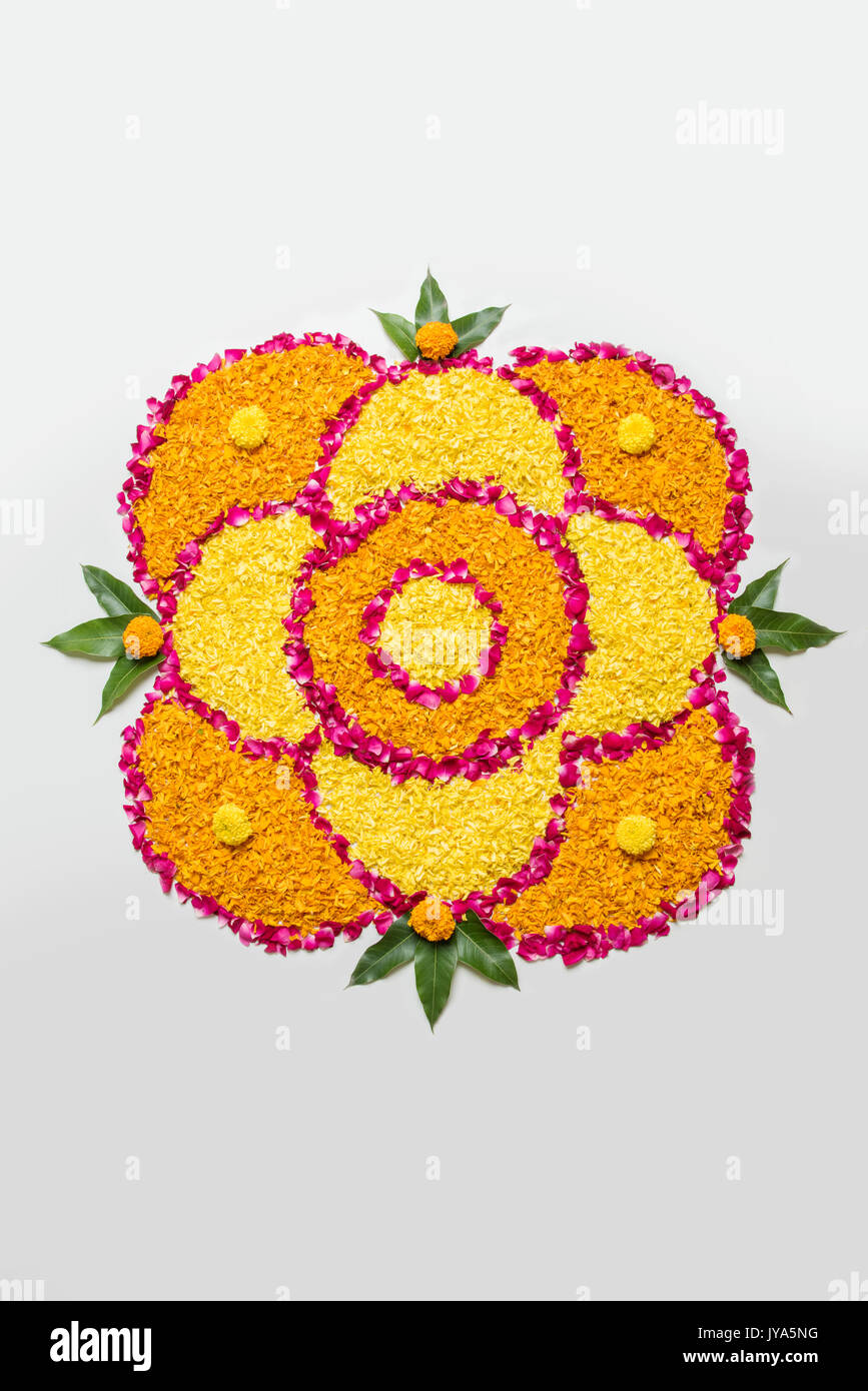flower rangoli for Diwali or pongal made using marigold or zendu ...