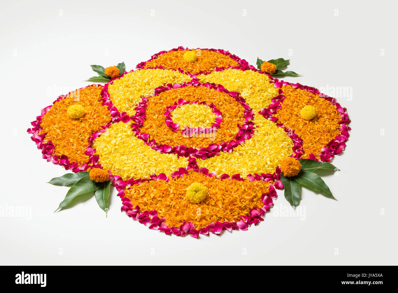 flower rangoli for Diwali or pongal made using marigold or zendu ...