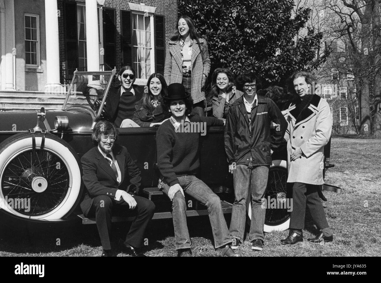 A group of undergraduate college students from Johns Hopkins University are gathered around a 1923 Rolls Royce Phantom during the University's annual spring fair, which included outdoor concerts, plays, rides, vendors, and more. April, 1975. Stock Photo