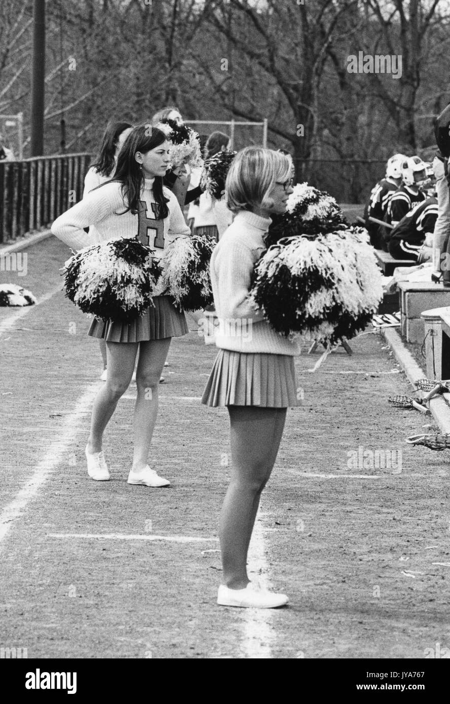 Female undergraduate students at Johns Hopkins University cheerlead during sporting event on the Homewood campus in Baltimore, Maryland during the first years that the university's undergraduate program admitted women. 1970. Stock Photo